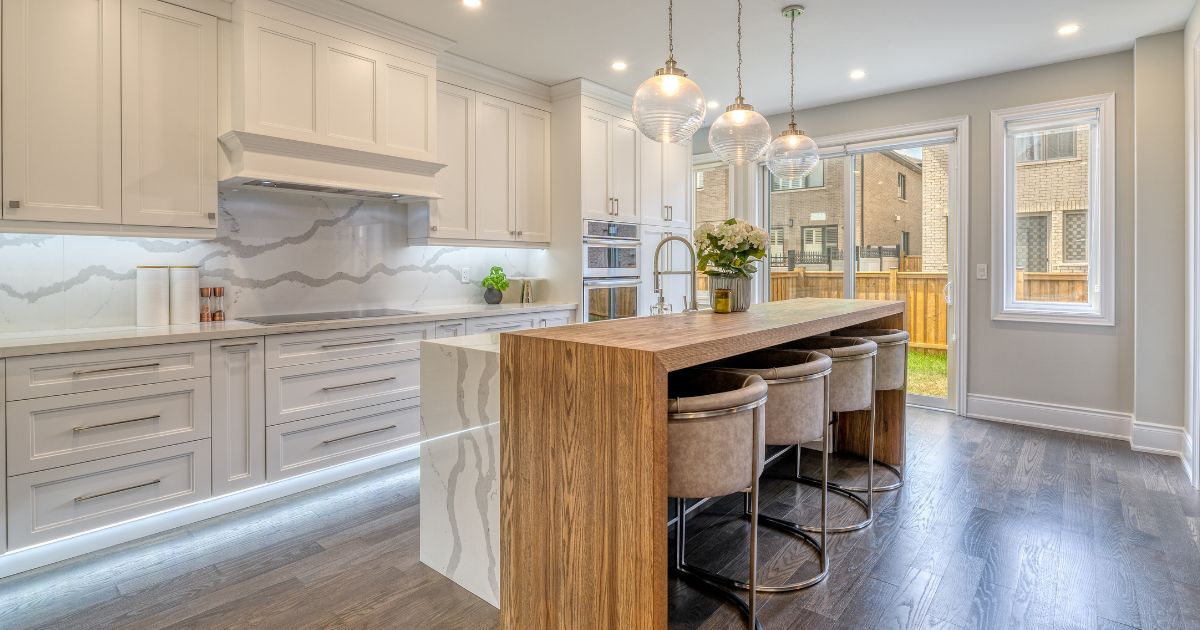 white kitchen with stone and wood countertop island