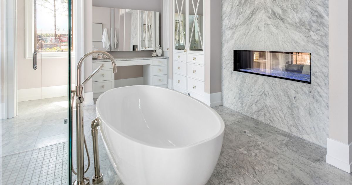 white master bathroom with free standing tub curbless shower and fireplace